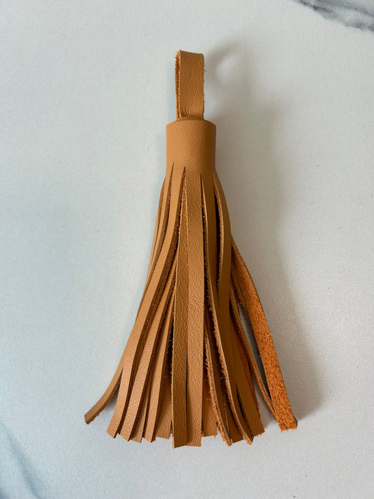 pup leather tassel $25